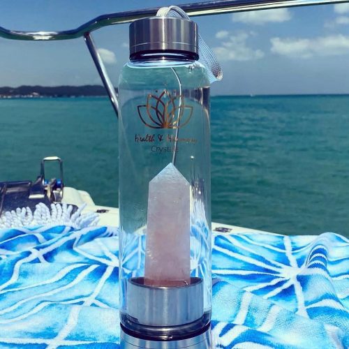 crystal water bottle on beach